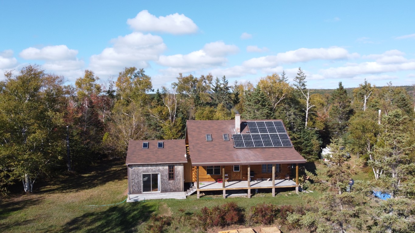 Drone shot of a finished solar array on a cottage roof