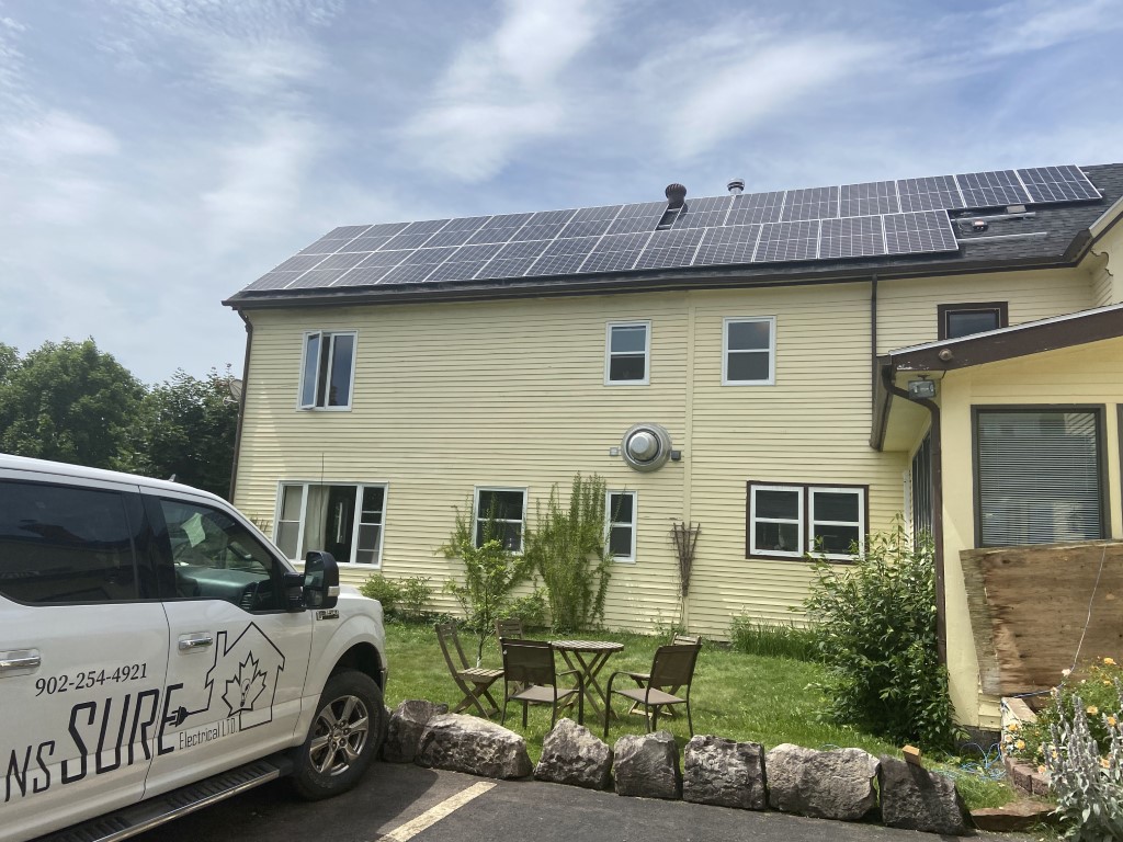 Solar panels installed on a steep, high roofline