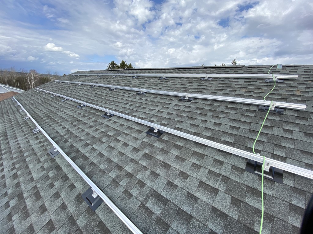 Mounting brackets laid out on a roof ahead of solar panel installation
